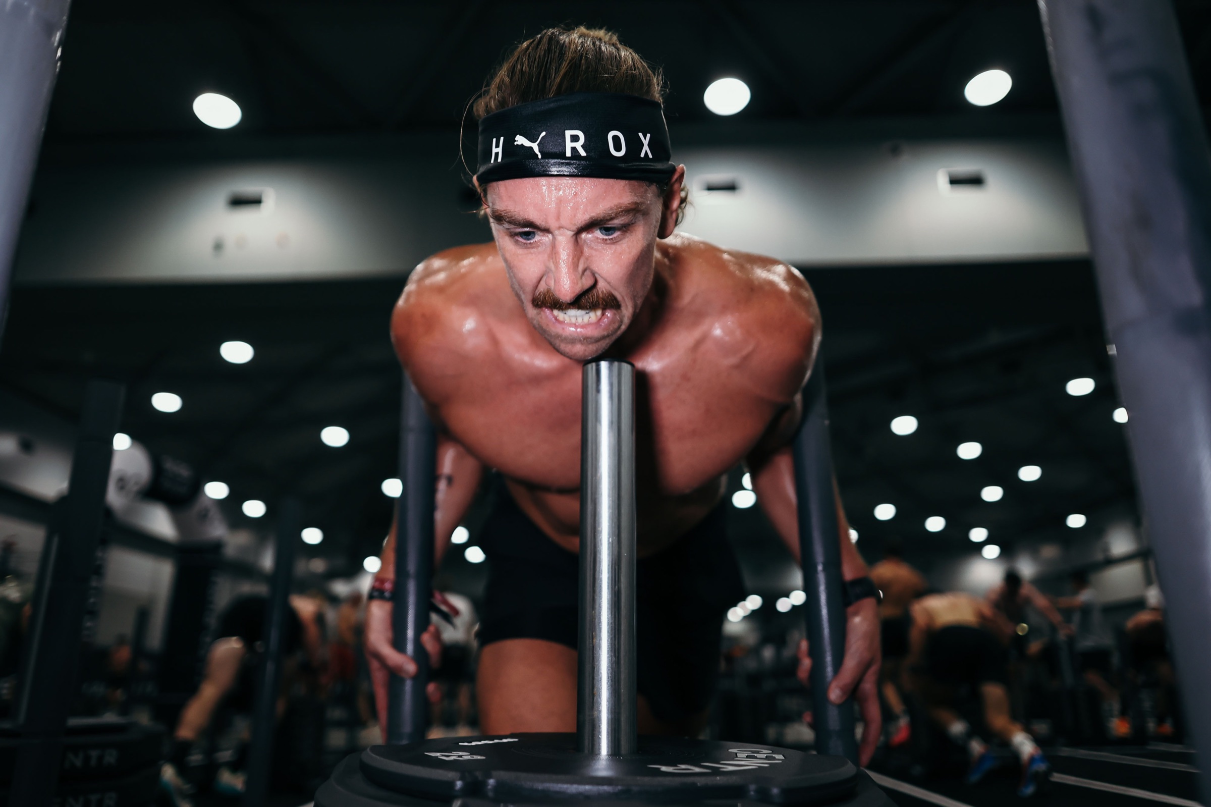 Peter Holst Jacobsen pushing a weighted sled during a HYROX race